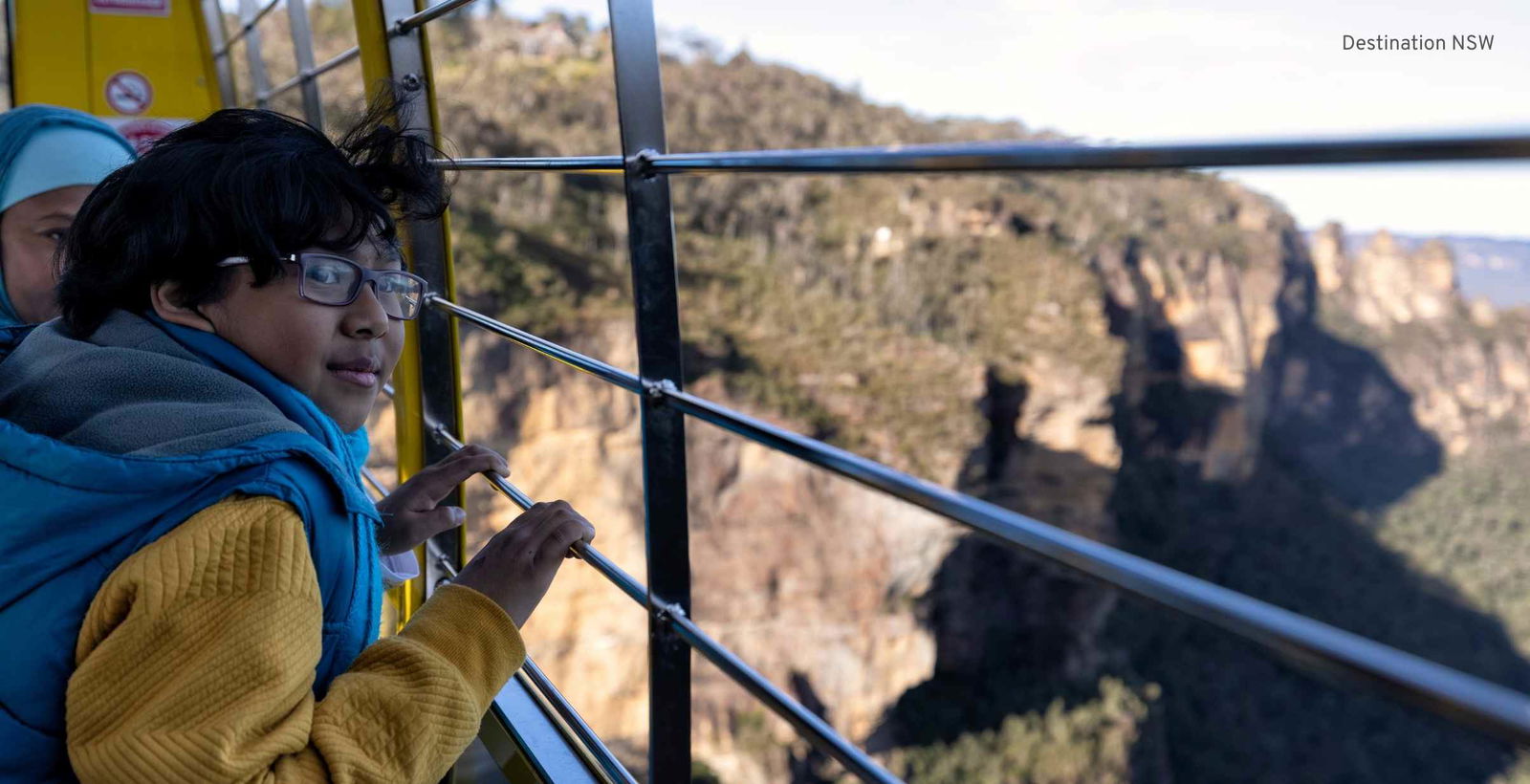 Young boy looking out from Sky Rail Gondola over the Blue Mountains