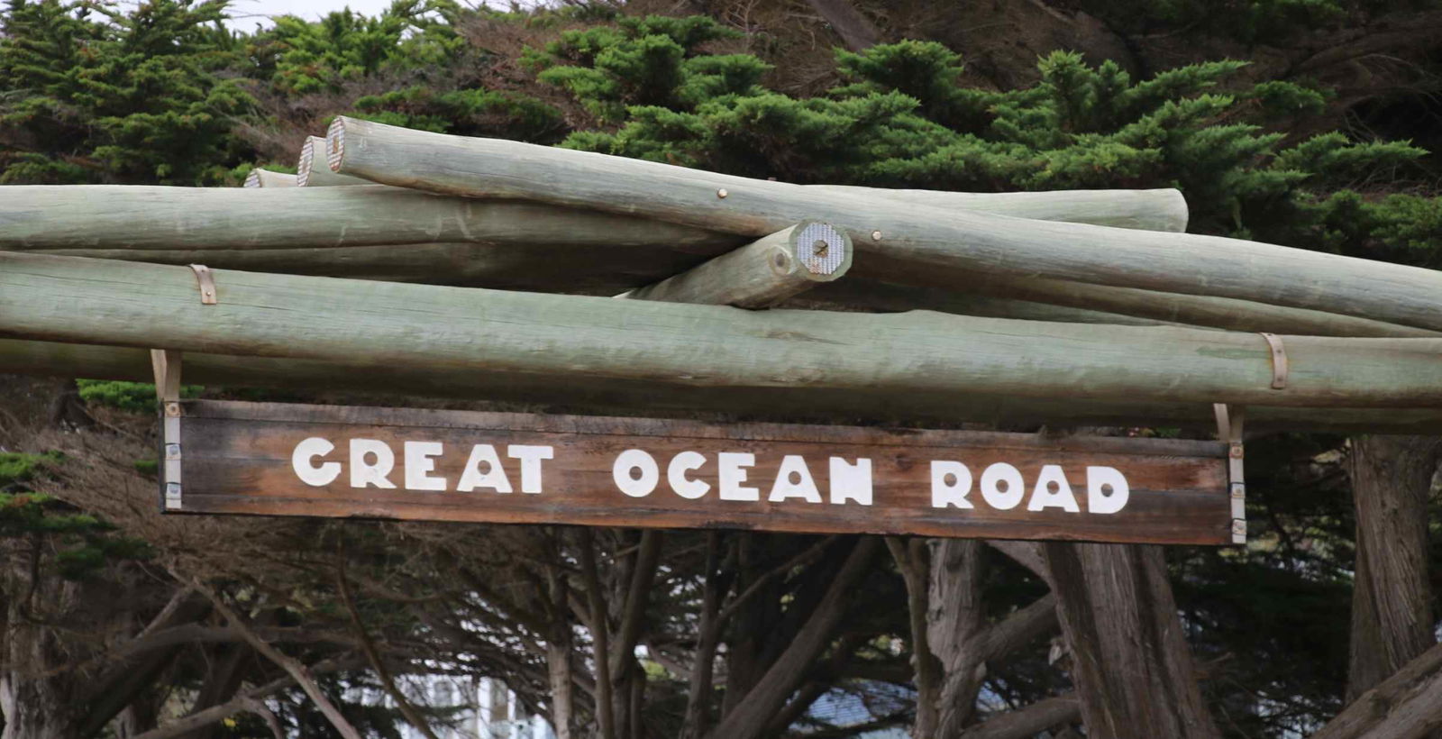 Close-up of Great Ocean Road wooden sign on the Memorial Arch.