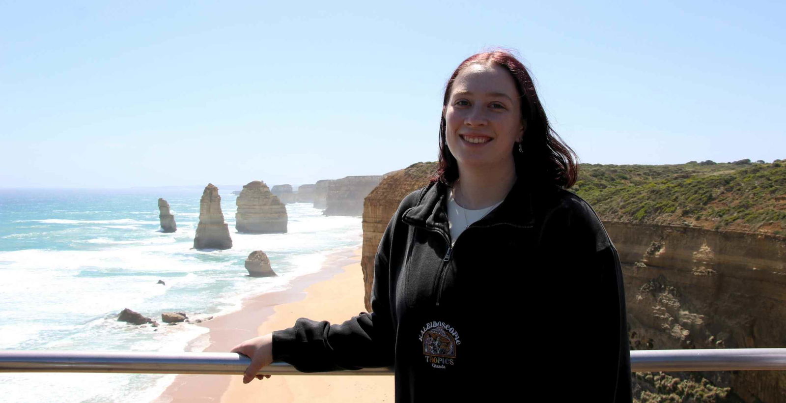Young woman posing for picture infront of 12 Apostles.