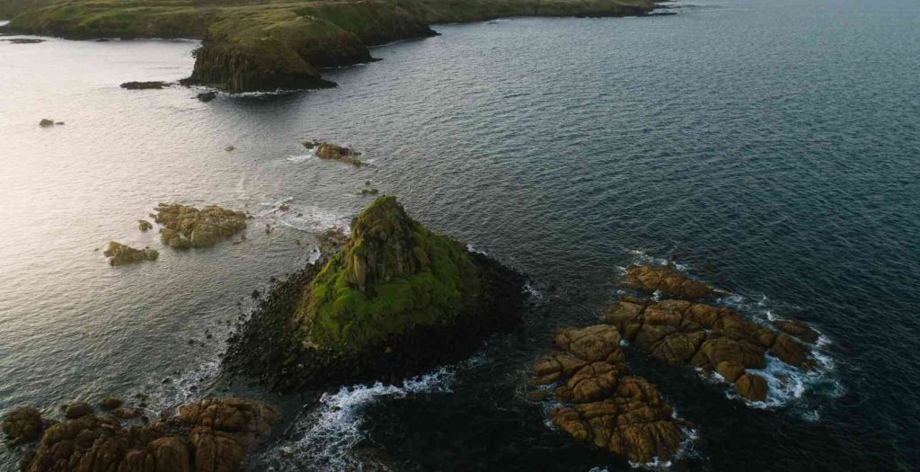 aerial view of the Nobbies rocks and sialnds surrounded by ocean at Phillip Island