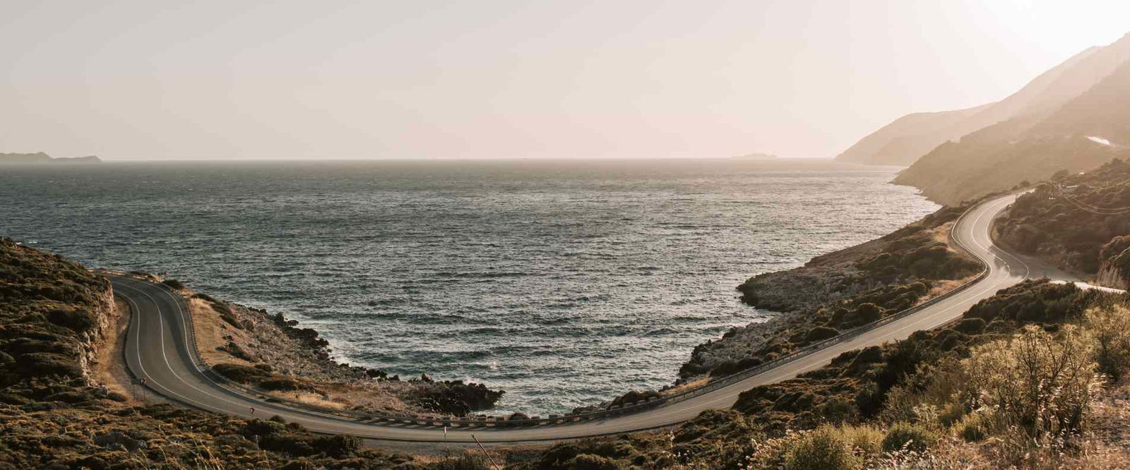 A lookout over the great ocean road highway and ocean at sunset