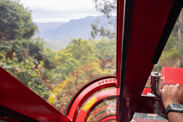 from the inside of a cable car looking at the view